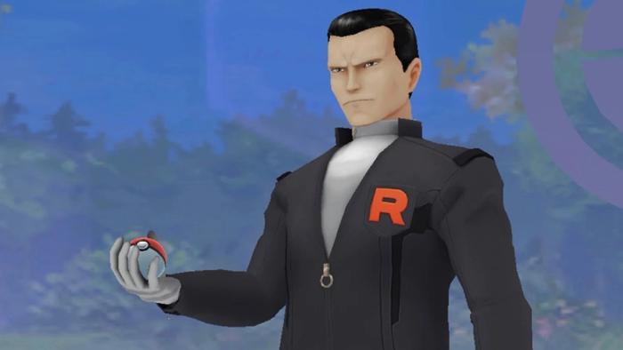 Giovanni from Pokémon GO carries a PokéBall and stares menacingly.