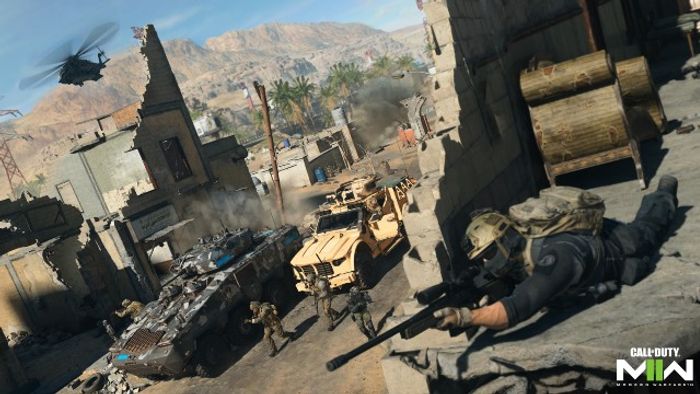 Modern Warfare 2 player laying down holding sniper rifle with vehicles in background