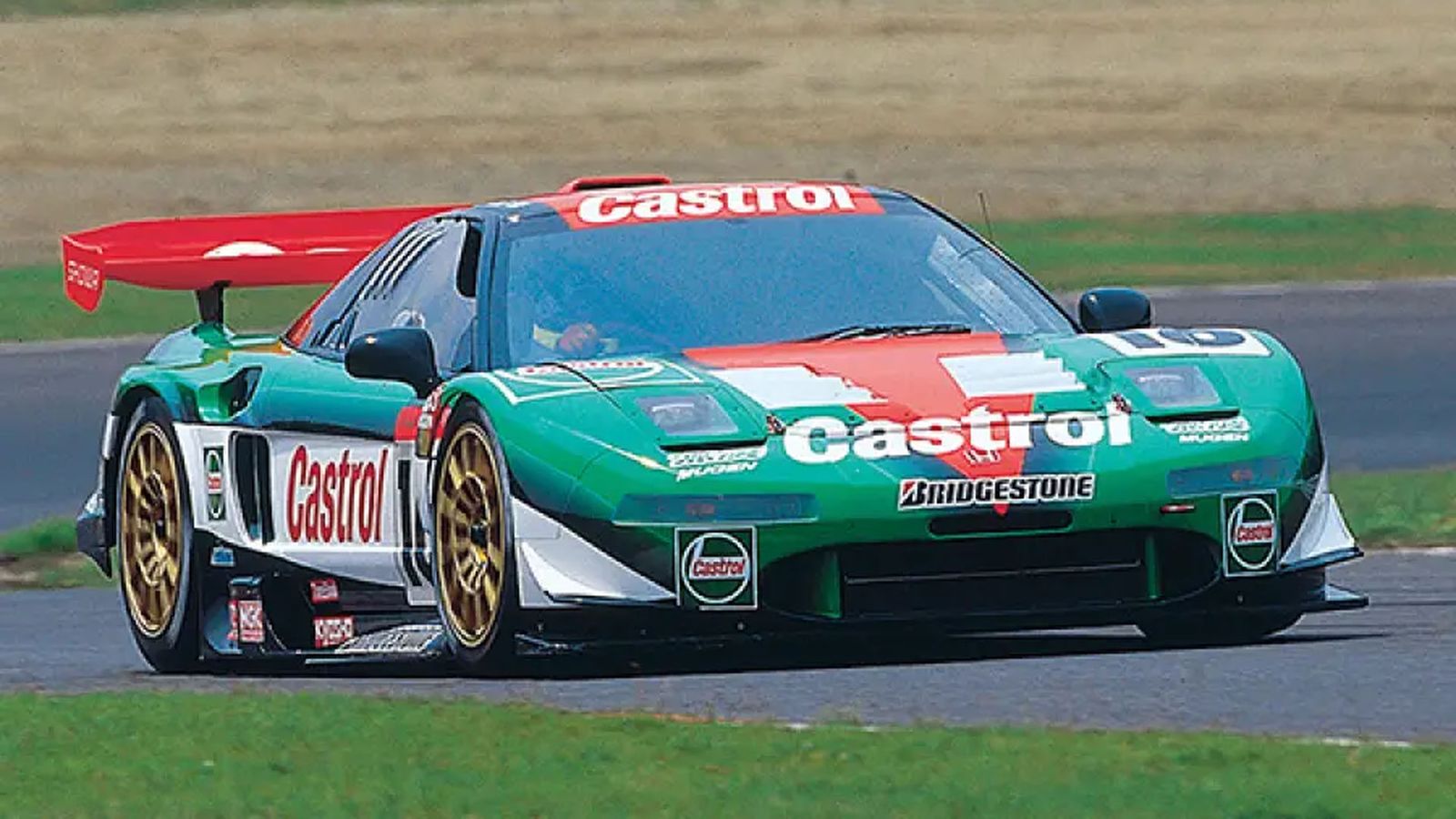 a castrol race car is driving down a track