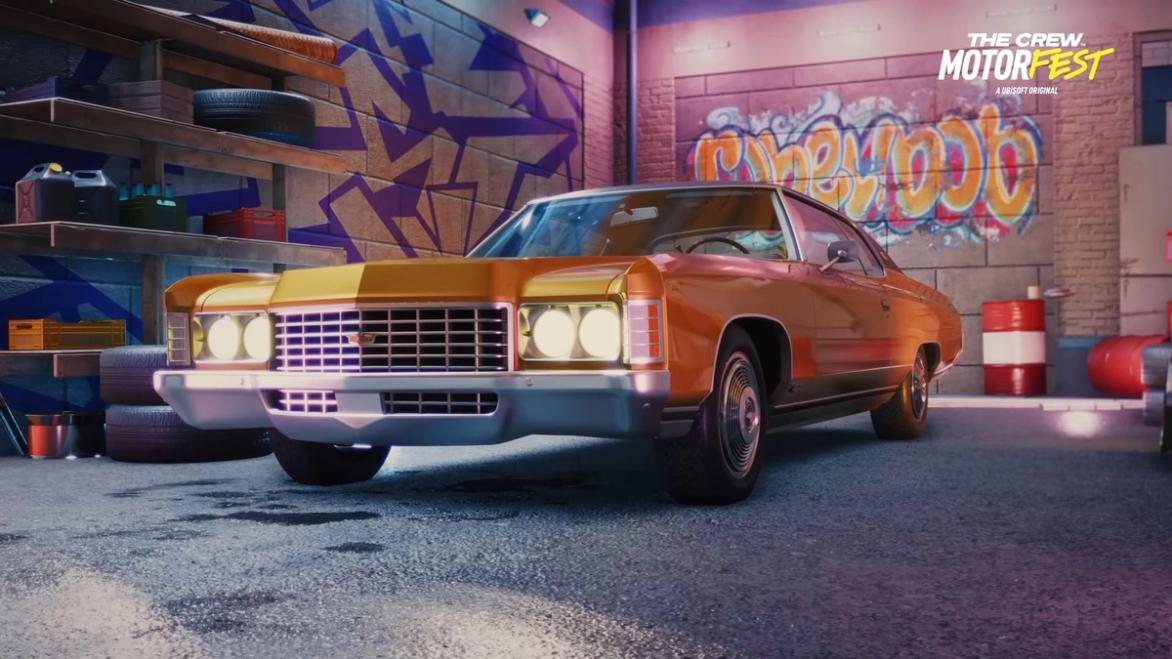 an orange car is parked in a garage with graffiti on the wall .