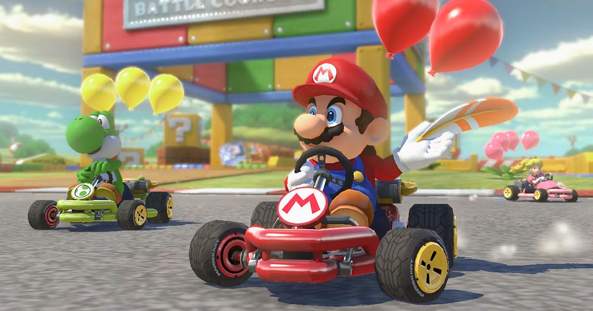 Mario driving a red cart with red ballons above the head and a feather in a hand, racing ahead of Yoshi.
