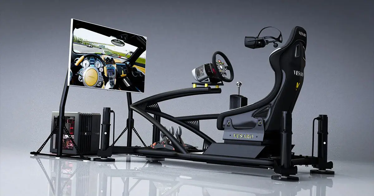 A black racing rig with seat, wheel, PC lit up in red, and a TV with a first person view in a car on the display.