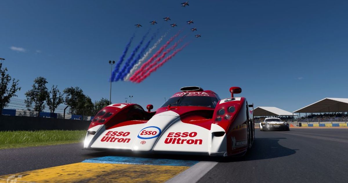 The GT-One driving under a french flag fly over in Gran Turismo 7