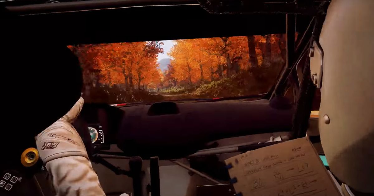 A shot from inside a rally car cockpit in DiRT Rally 2.0 featuring a driver and co-pilot with a notepad in front of them.