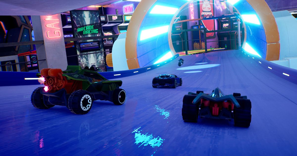 Three Hot Wheels cars behind a bike, racing on a blue track going into an orange tunnel of blue light.