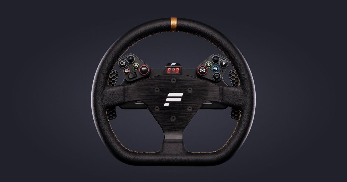 A black Fanatec-branded racing wheel with a gold centering line at the top in front of a gray background.