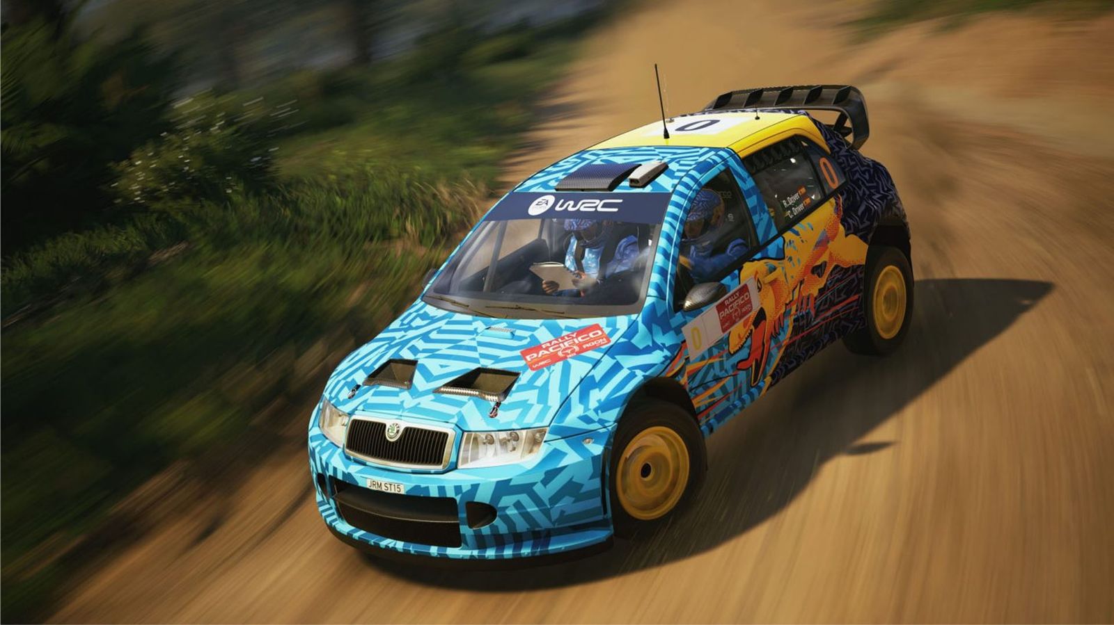 a blue and yellow rally car is driving down a dirt road .