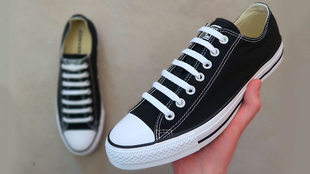 Image of black Converse sneakers with white laces going straight over the tongues.