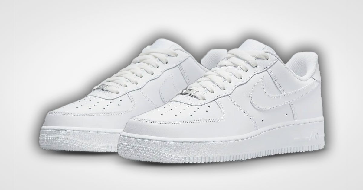 A pair of all-white Nike Air Force 1 low-tops featuring a black glow around them.