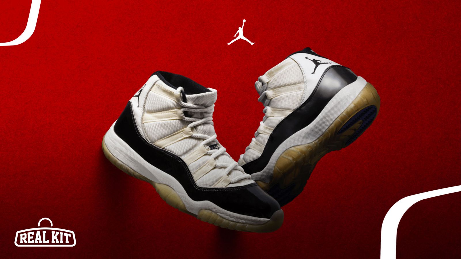 Image of the original white and black Jordan 11s in front of a red background.