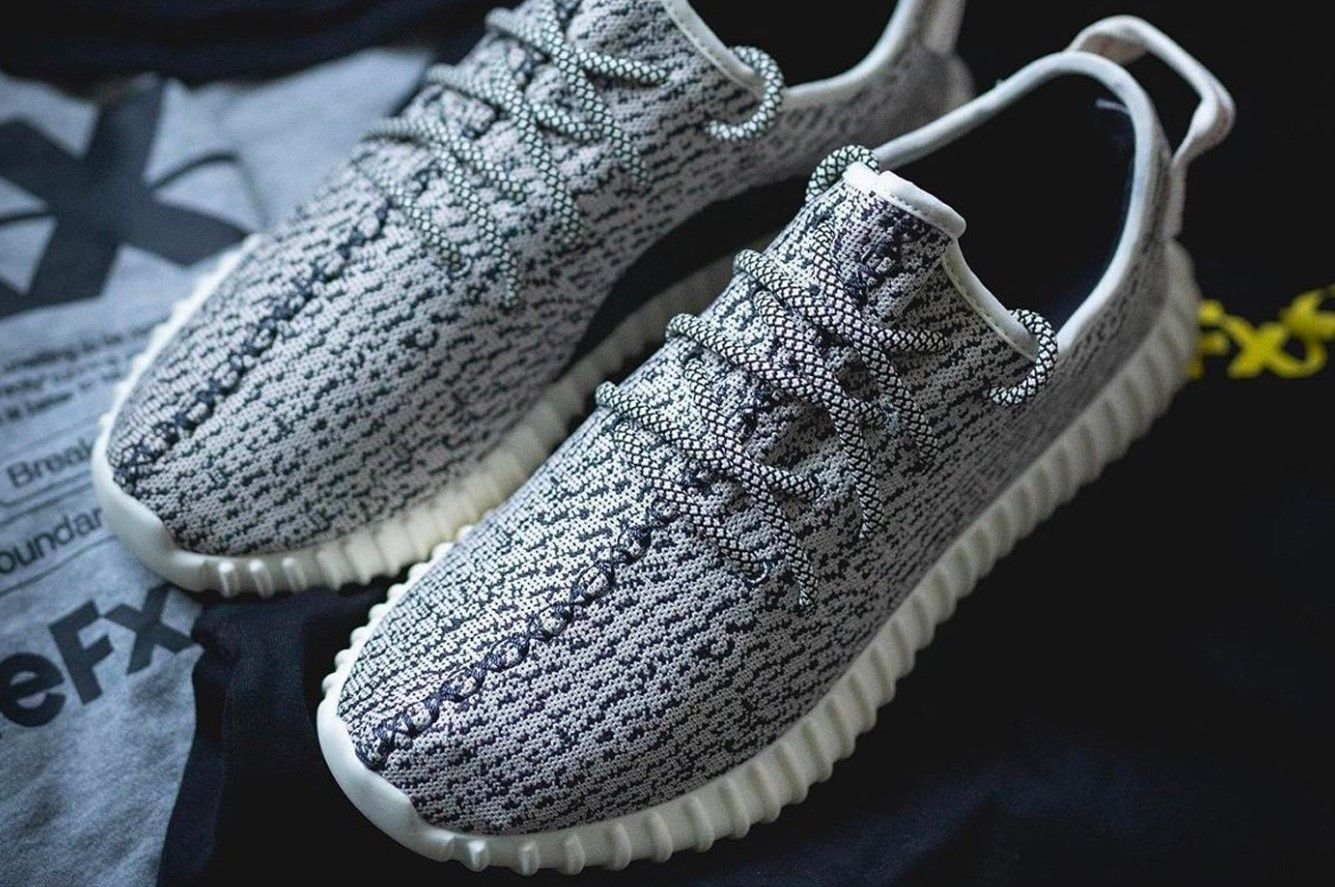 adidas Yeezy Boost 350 "Turtle Dove" product image of grey and black fabric sneakers with white Boost midsoles.