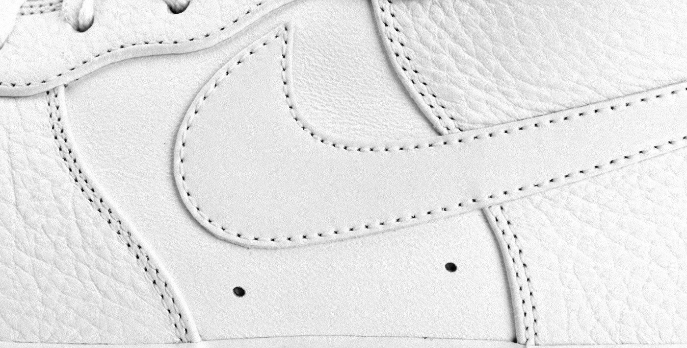 Nike Air Force 1 product image of a white sneaker close up.