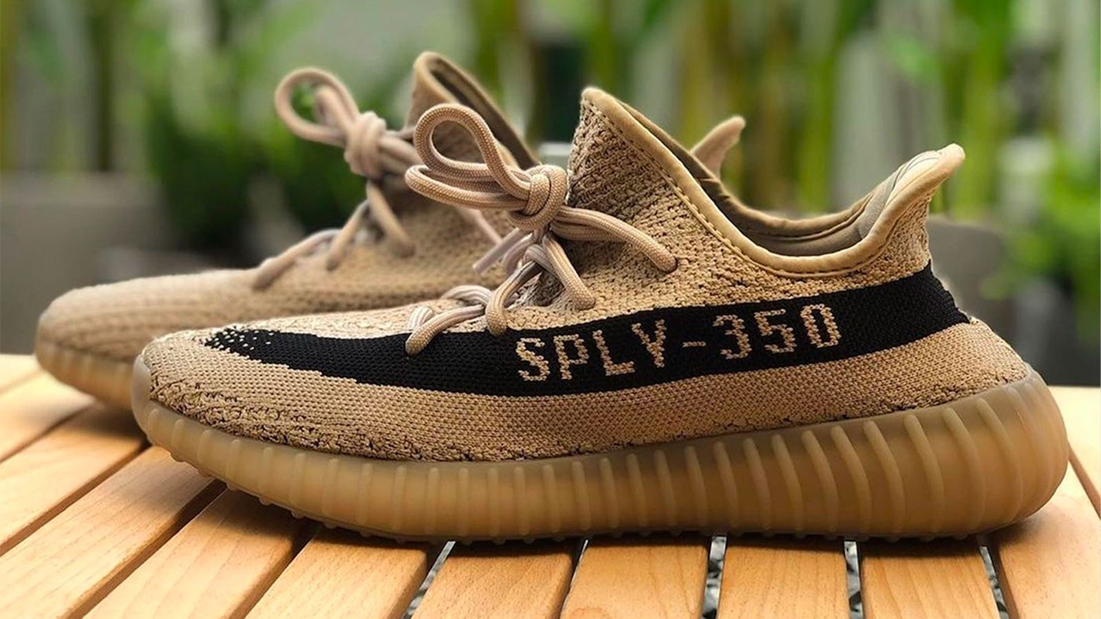 adidas Yeezy Boost 350 v2 "Beige/Black" product image of a beige pair of sneakers with black stripes down the lateral sides containing the 'SPLY-350' branding.