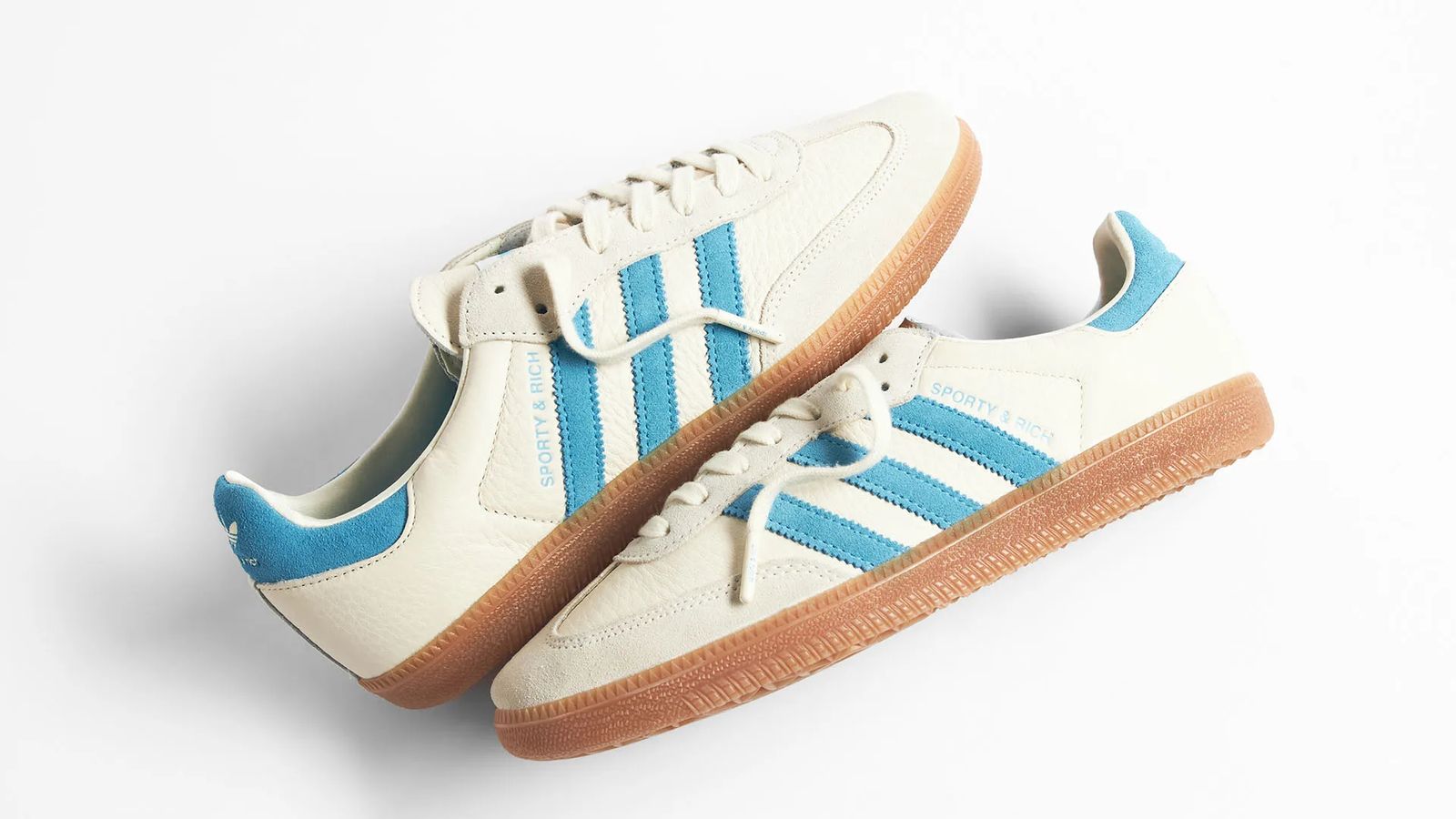 Sporty & Rich x adidas Samba "Cream Blue" product image of a cream white leather and suede pair of low-tops with light blue stripes and details and a gum rubber sole.