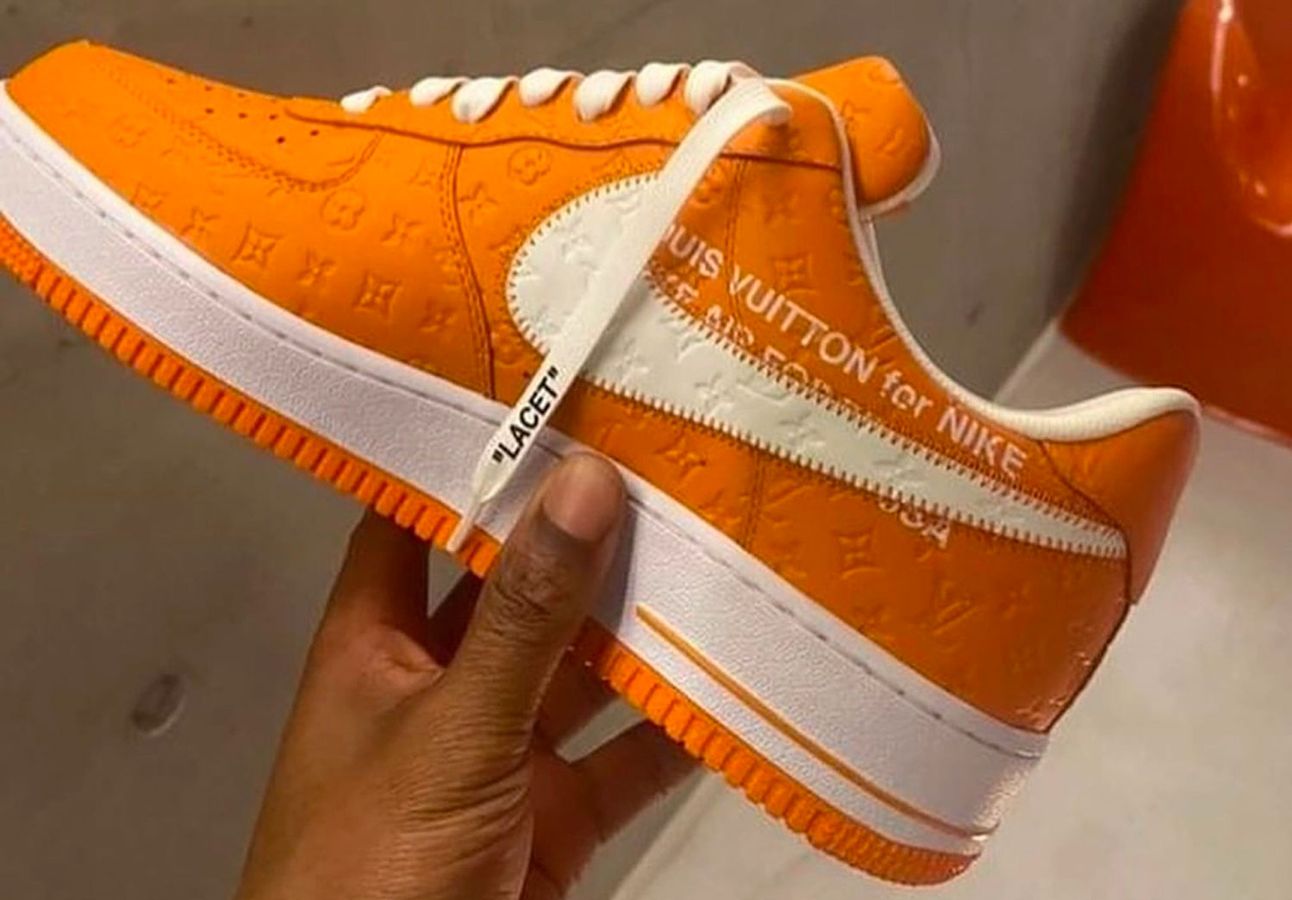 Louis Vuitton x Off-White x Nike Air Force 1 product image of an orange and white LV debossed sneaker.