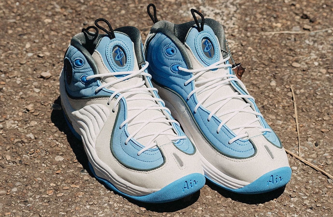 Social Status x Nike Air Max Penny 2 "Playground" product image of a white pair of sneakers with light blue accents and a grey lining.