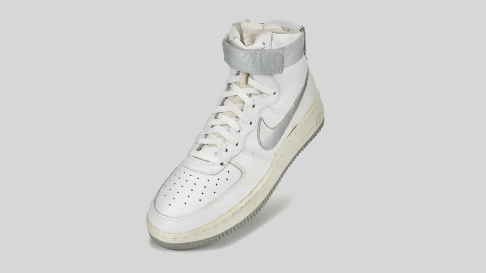 Image of an original Air Force 1 high-top in white with grey accents.