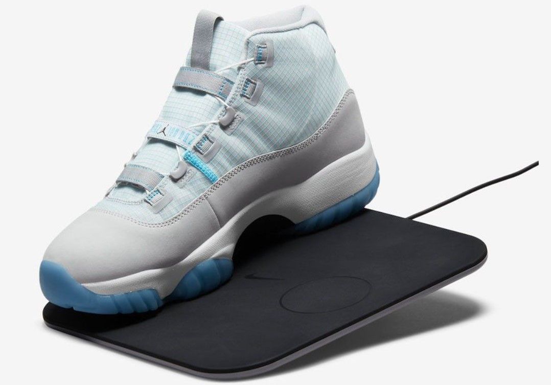 Air Jordan 11 Adapt product image of a white and light blue sneaker.