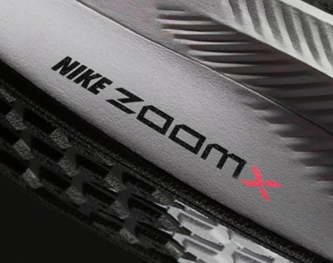 Nike Zoom X Foam product image close-up of Nike Zoom X branding in black and red.