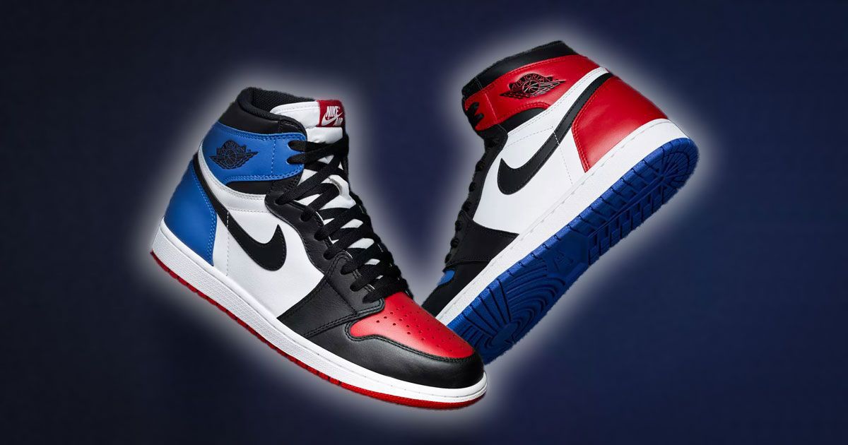 A pair of white, black, red, and blue Jordan 1 Highs in front of a blue background with a white glow around each shoe.