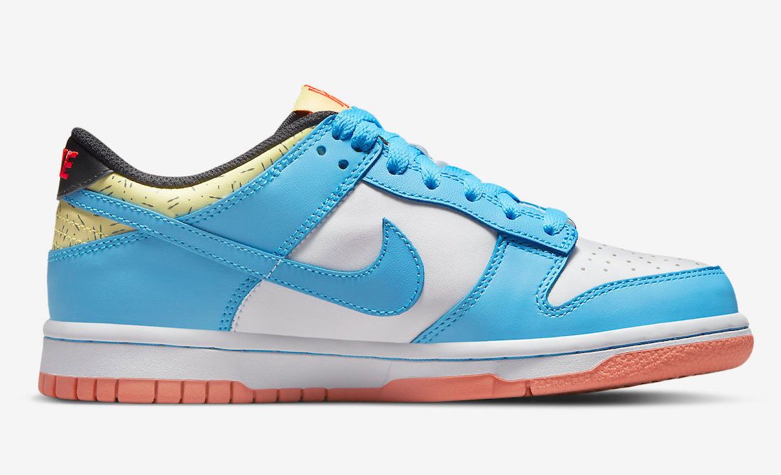 Kyrie Irving Nike Dunk Low product image of a white and light blue sneaker with hints of yellow, red, as well as a pink rubber outsole.