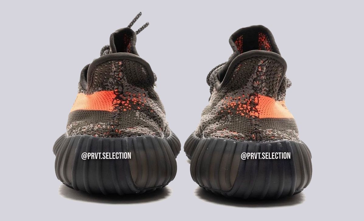 adidas Yeezy Boost 350 v2 "Dark Beluga" product image of deep grey, knitted sneakers with Solar Red stripes down the lateral sides.