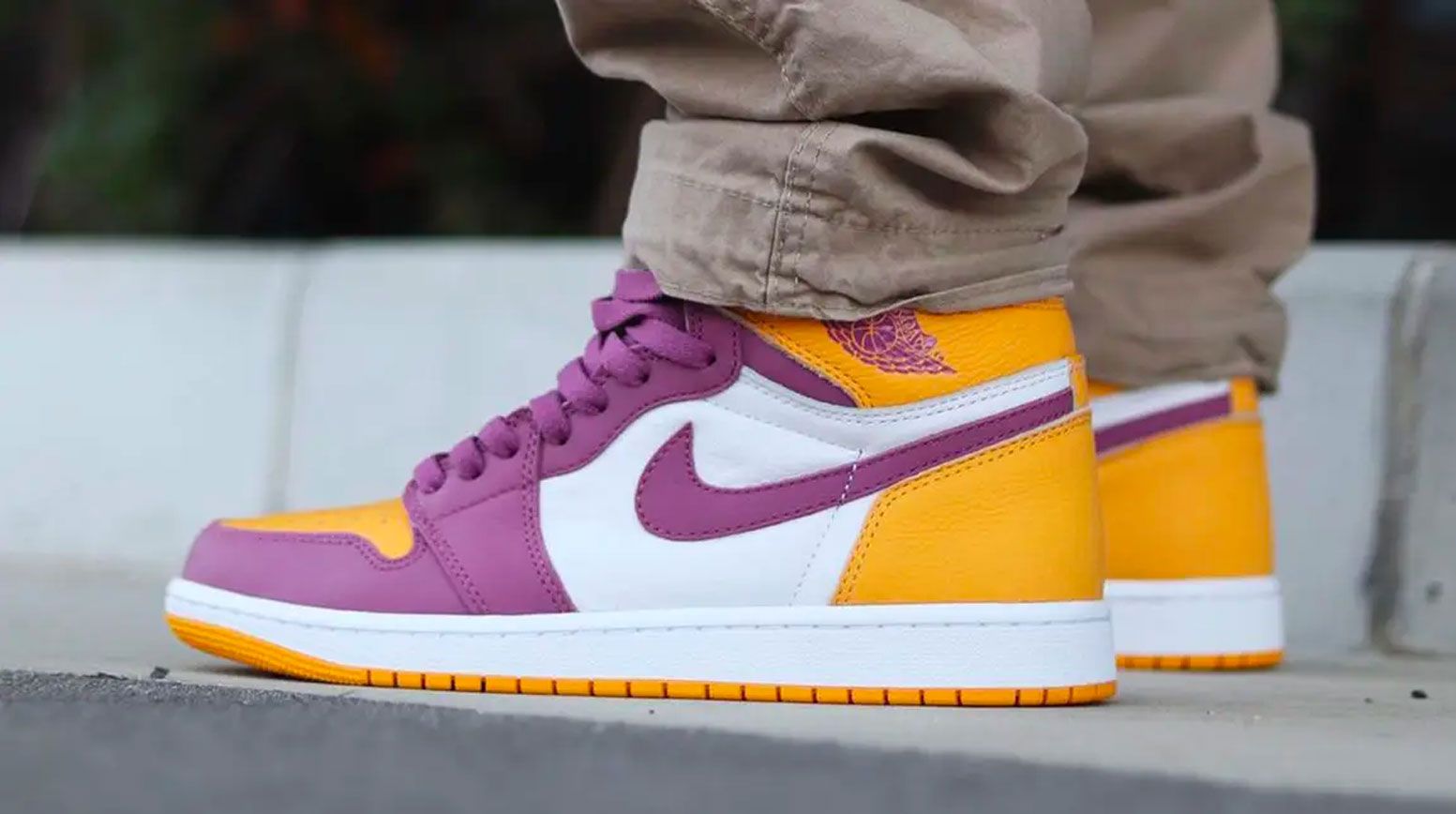 Air Jordan 1 "Brotherhood" product image of a yellow, purple and white sneaker.