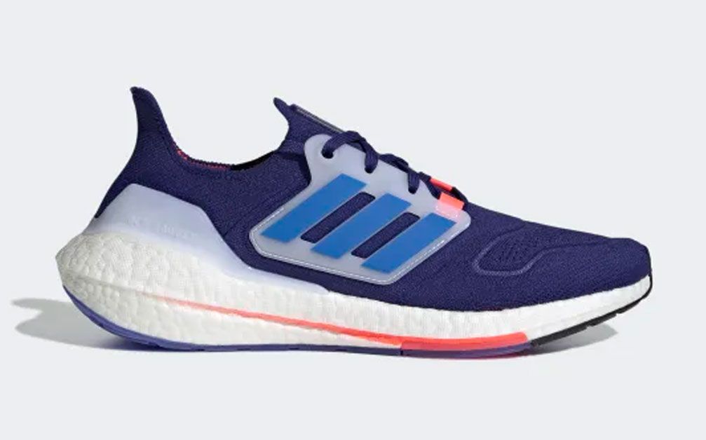 adidas Ultraboost 22 product image of a blue knitted sneaker with pink and white details. 