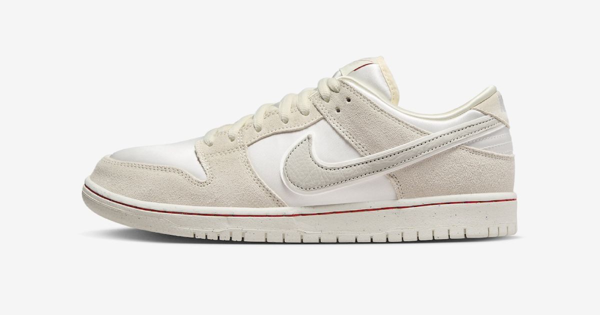 Nike SB Dunk Low "Coconut Milk" product image of a coconut milk-colored low-top featuring suede bone-colored overlays and a red line around the midsole.