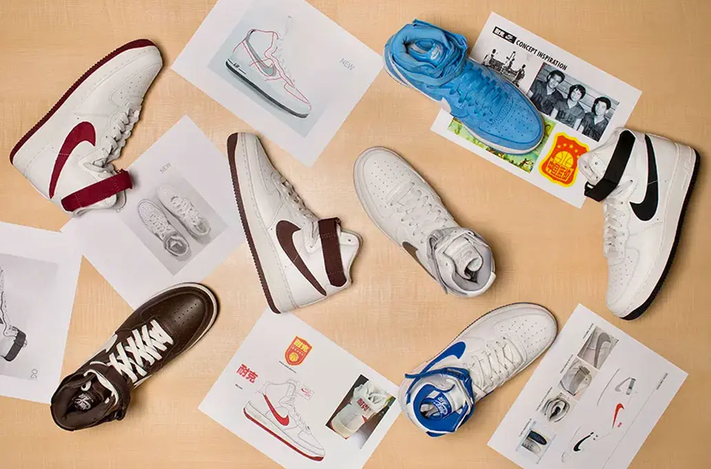 Nike Air Force 1 Highs in red, brown, white, black, and blue on a table next to their original drawings.