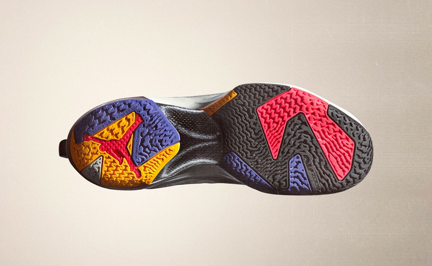 Air Jordan 37 product image of a black outsole with mutli-coloured accents.