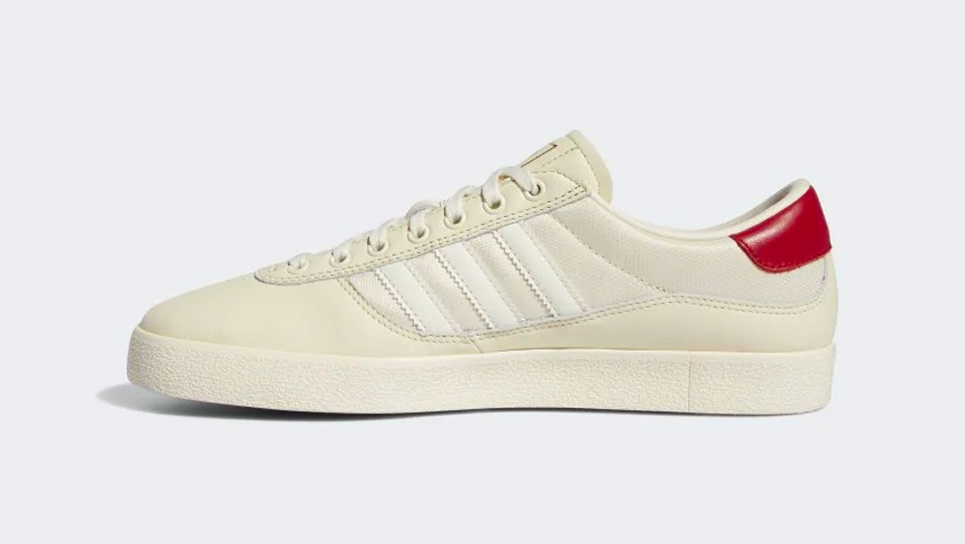 adidas Puig Indoor Shoes product image of a cream white and scarlet sneaker.