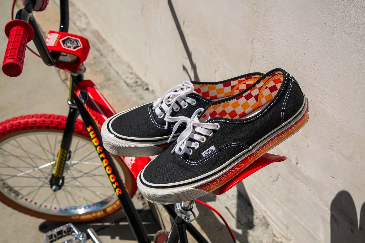 Vans x Mongoose Presented By Our Legends product image of a pair of black and white sneakers with a red, yellow, and orange checkerboard interior.