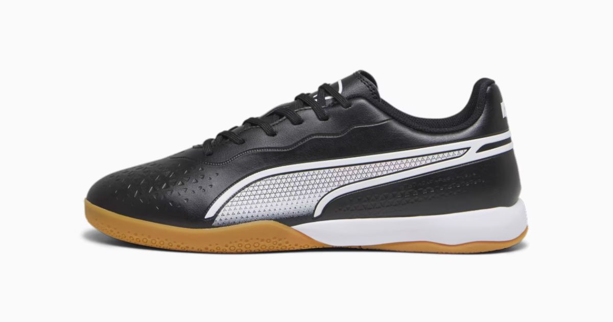 PUMA KING MATCH IT product image of a black and white low-top trainer with a gum rubber outsole.