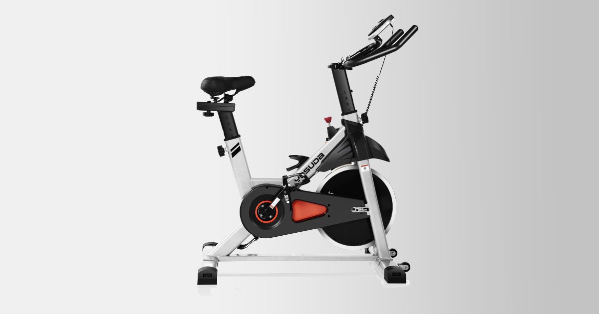 A black and silver metal exercise bike with orange trim.