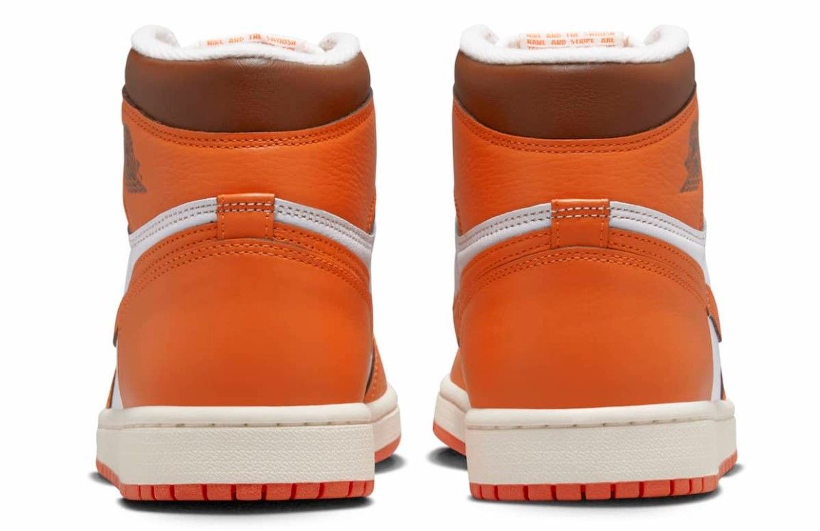 Air Jordan 1 High OG "Starfish" product image of a white leather sneaker with orange overlays and black details.