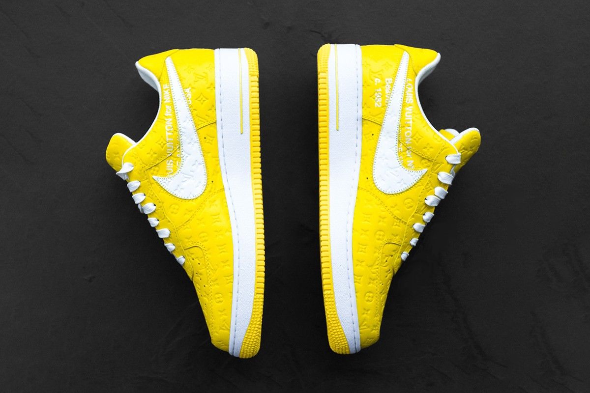 Louis Vuitton x Off-White x Nike Air Force 1 product image of an yellow and white LV debossed sneaker.