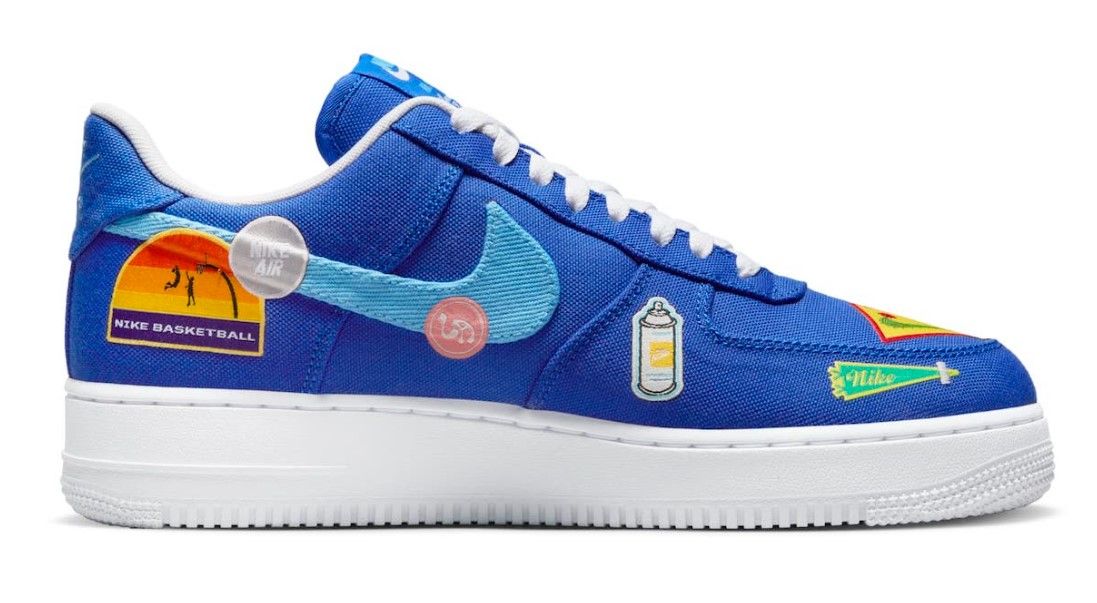 Nike Air Force 1 "Los Angeles" product image of dark blue canvas sneakers featuring several LA-themed patches. 