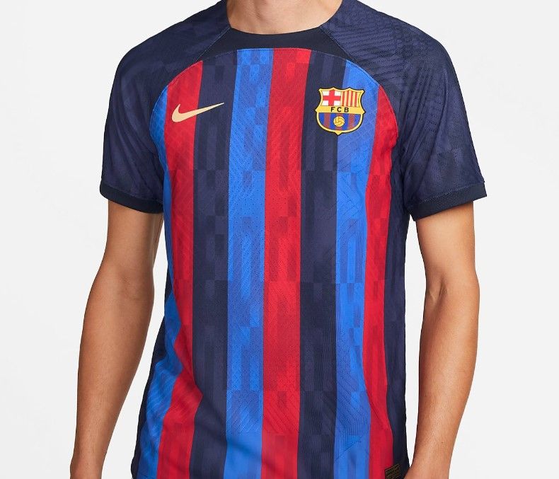 Barcelona home kit 2022/23 render image of a dark blue shirt with red and lighter blue stripes.