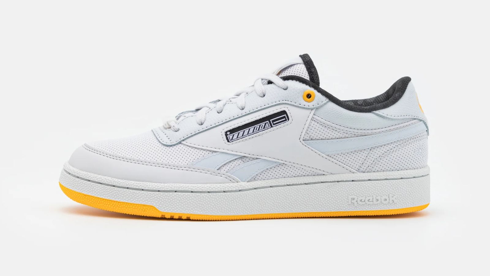 Reebok Club C Revenge "Jurassic World" product image of a white low-top sneaker with a yellow outsole and black interior.