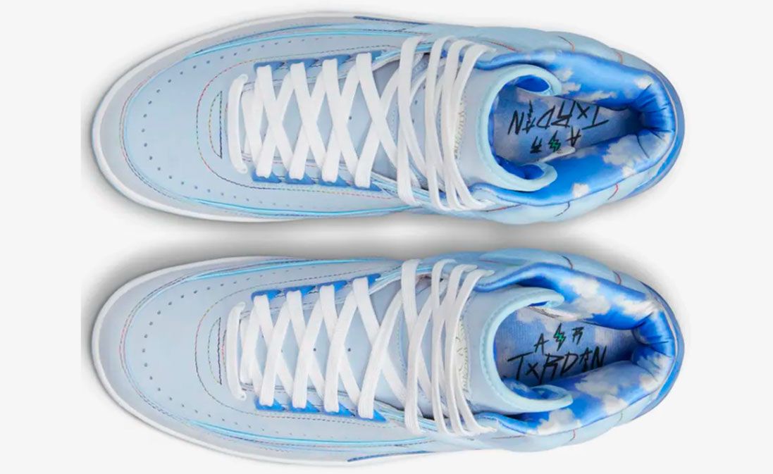 J Balvin x Air Jordan 2 product image of a light blue sneaker with sky blue overlays featuring cloudy graphics.