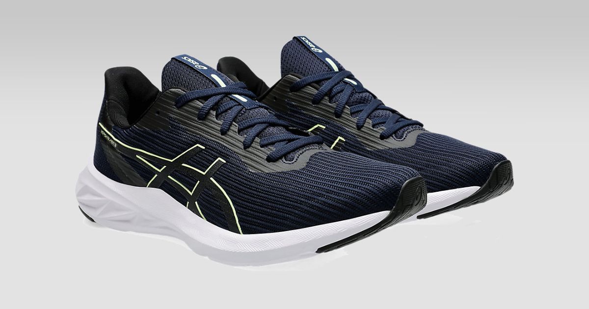 A pair of dark blue mesh and white ASICS running shoes with lime green trim.