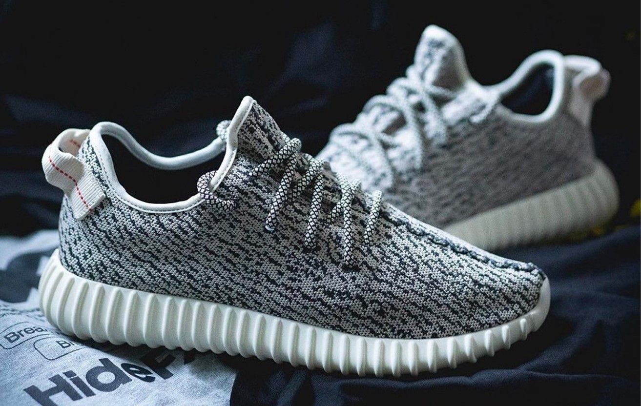 adidas Yeezy Boost 350 "Turtle Dove" product image of grey and black fabric sneakers with white Boost midsoles.