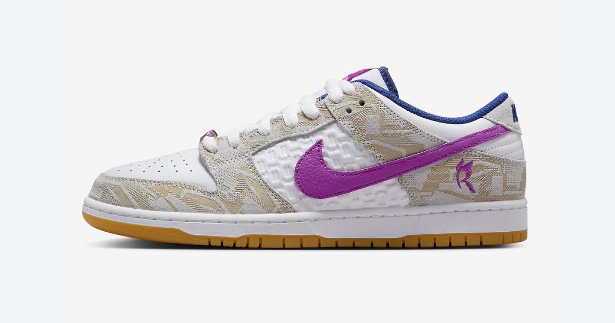 Rayssa Leal x Nike SB Dunk Low "Vivid Purple" product image of a white low-top featuring engraved light brown overlays, blue lining, and purple Swoosh down the sidewall.