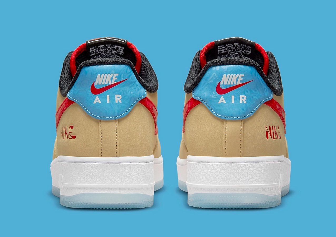 Nike Air Force 1 "Satellite" product image of a tan leather sneaker with blue and red details.