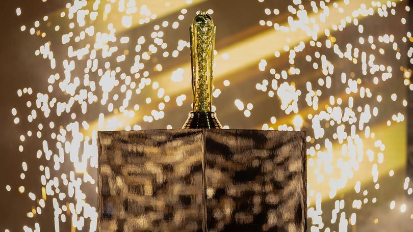 a trophy is sitting on top of a wooden box with sparklers coming out of it .