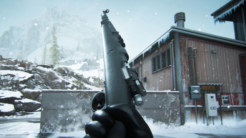 Warzone player holding Kar98k marksman rifle with snow-covered building and rocks in background