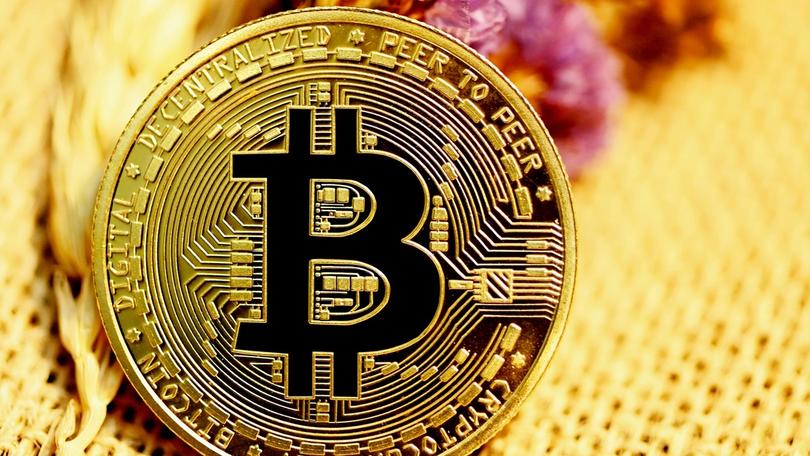 a close up of a bitcoin coin on a table .