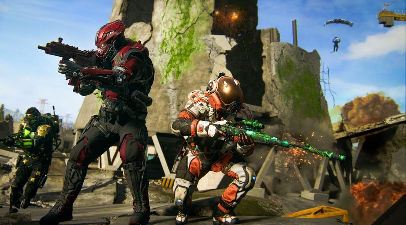 Warzone players posing with weapons in front of broken building.