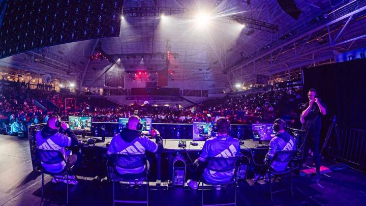 Toronto Ultra Call of Duty League players sat playing on stage in front of a crowd